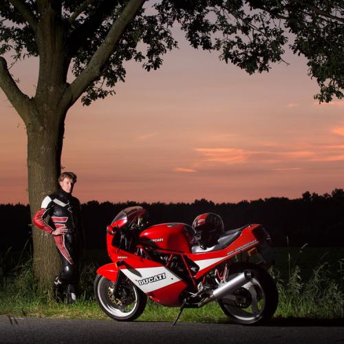 Porträtfoto eines Motorradfahrers mit seinem Motorrad im Sonnenuntergang